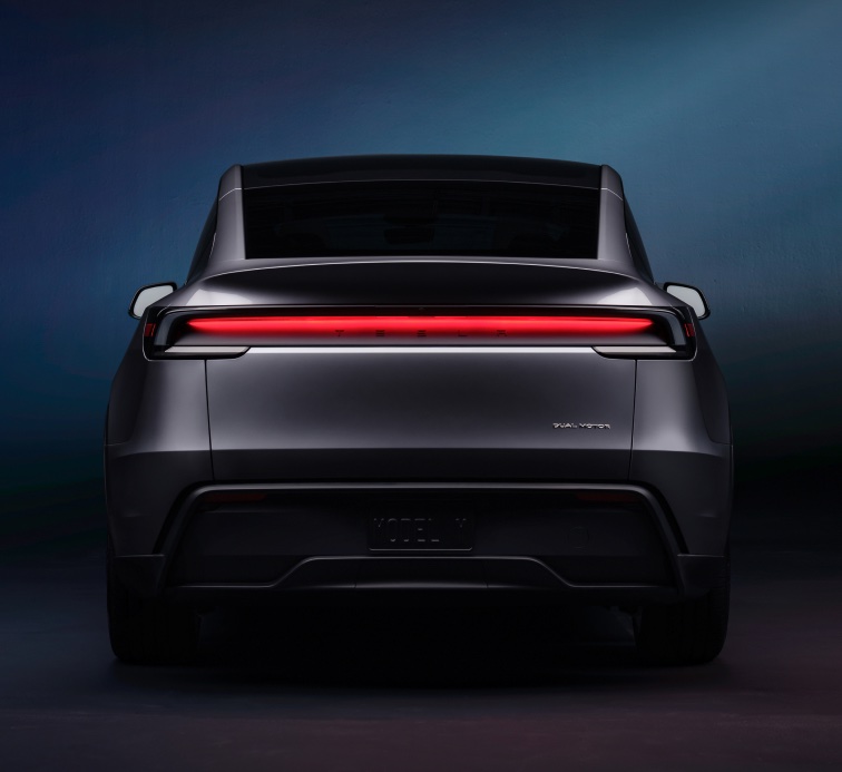 Rear view of a Tesla in a dark studio